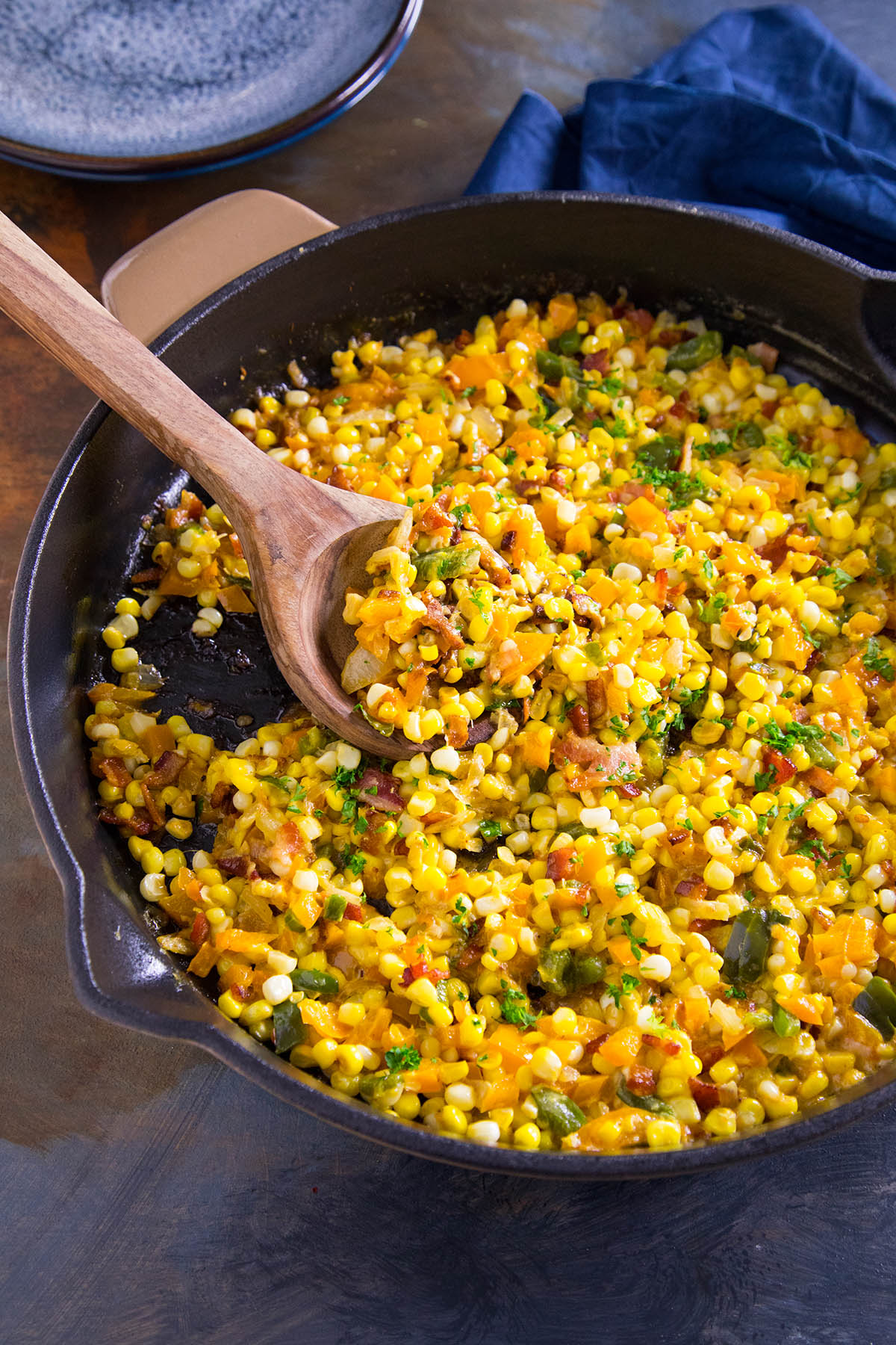 Cajun Maque Choux is a classic southern dish of bacon, corn and peppers with a bit of cream.