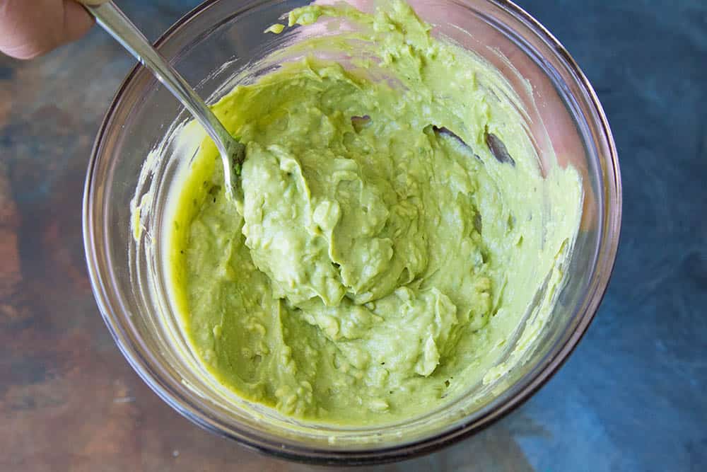 Making the creamy guacamole to top our Turkey-Chorizo burgers.