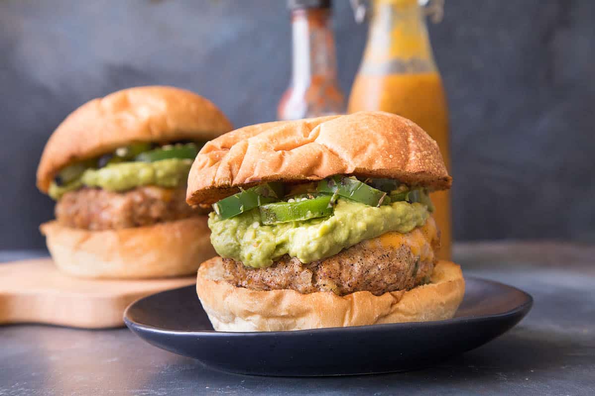 Turkey-Chorizo Burgers with Creamy Guacamole plated and ready to eat.