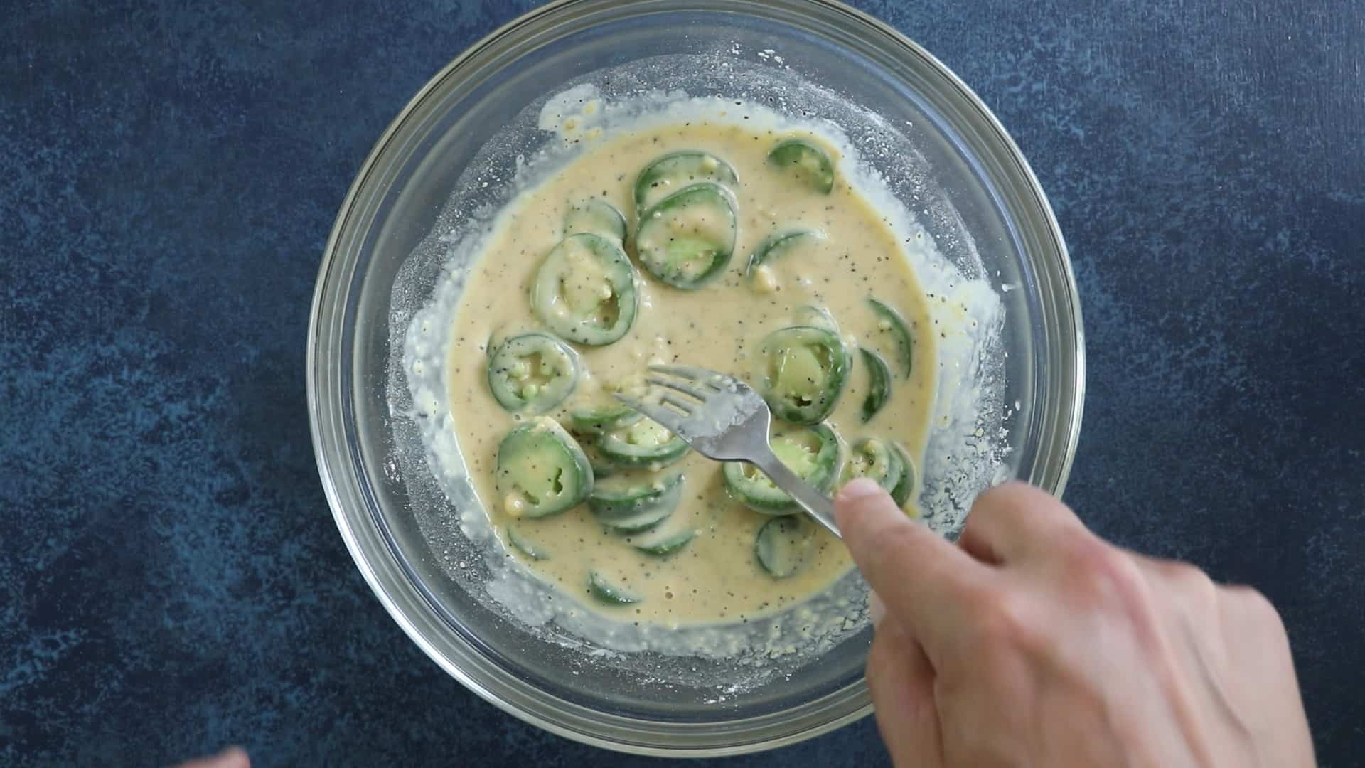 Battering the jalapeno peppers.