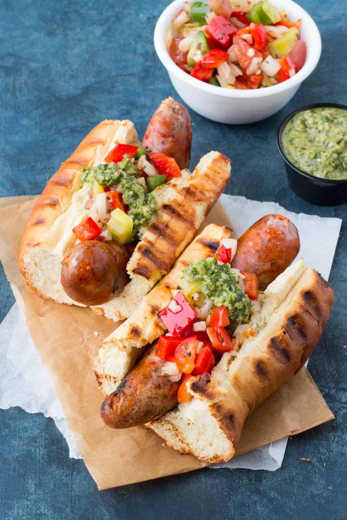 choripán argentina grilled chorizo with chimichurri and salsa criolla