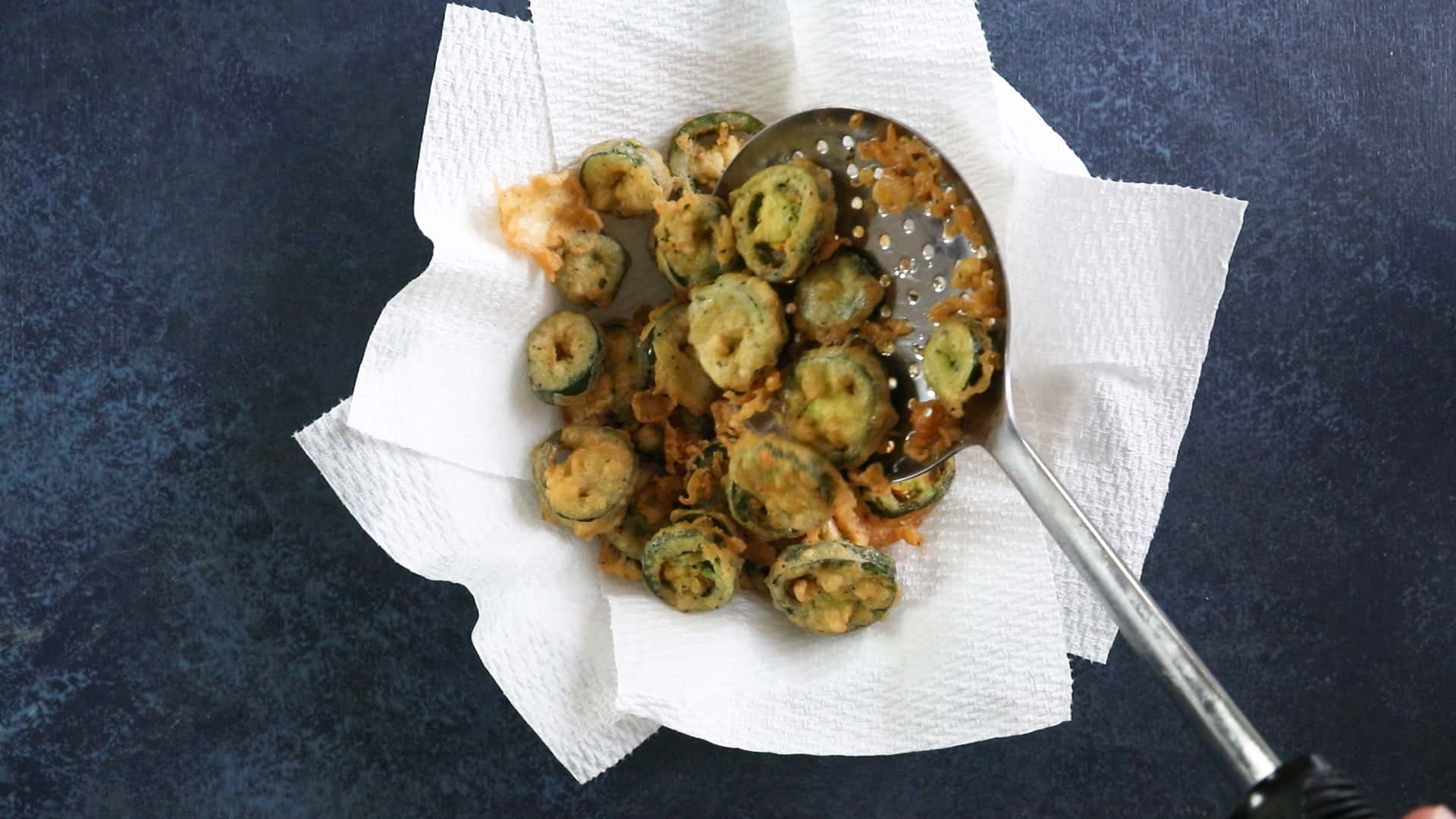 Drain the fried jalapeno peppers on paper towels