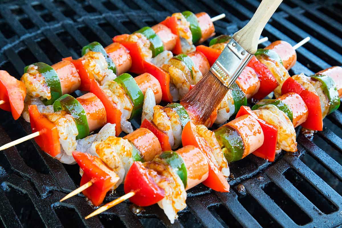 Glazing the Shrimp and Sausage Skewers