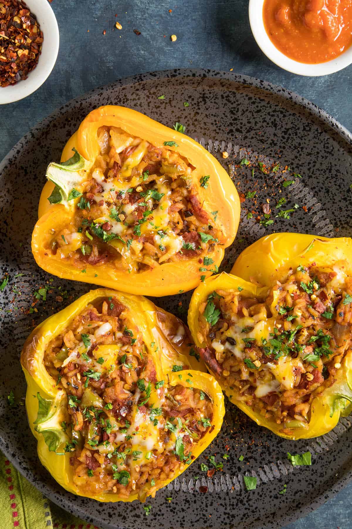 These Vegetarian Stuffed Peppers are stuffed with loads of spicy rice, cheese and more.
