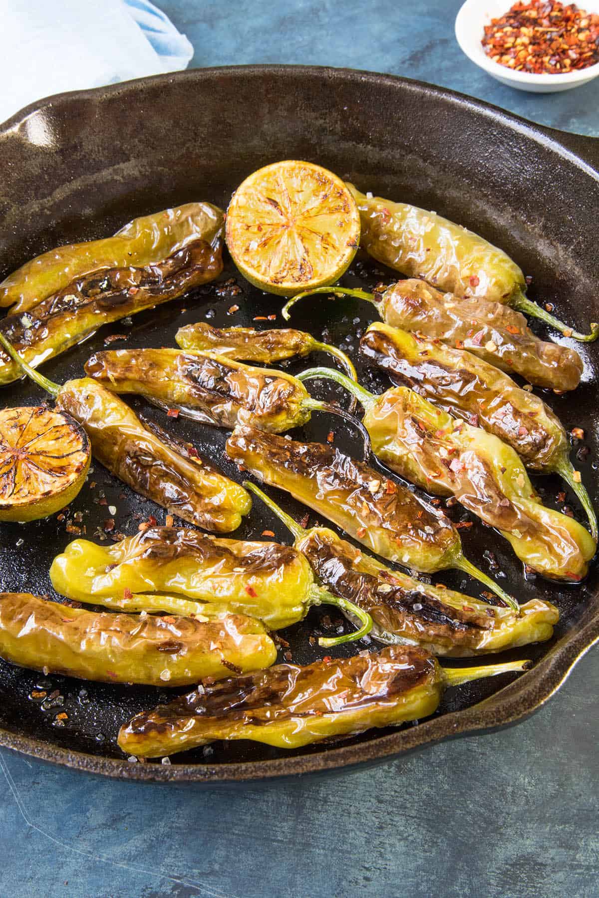 Blistered Shishito Peppers - Dusted with flaky sea salt, lime juice and chili flakes