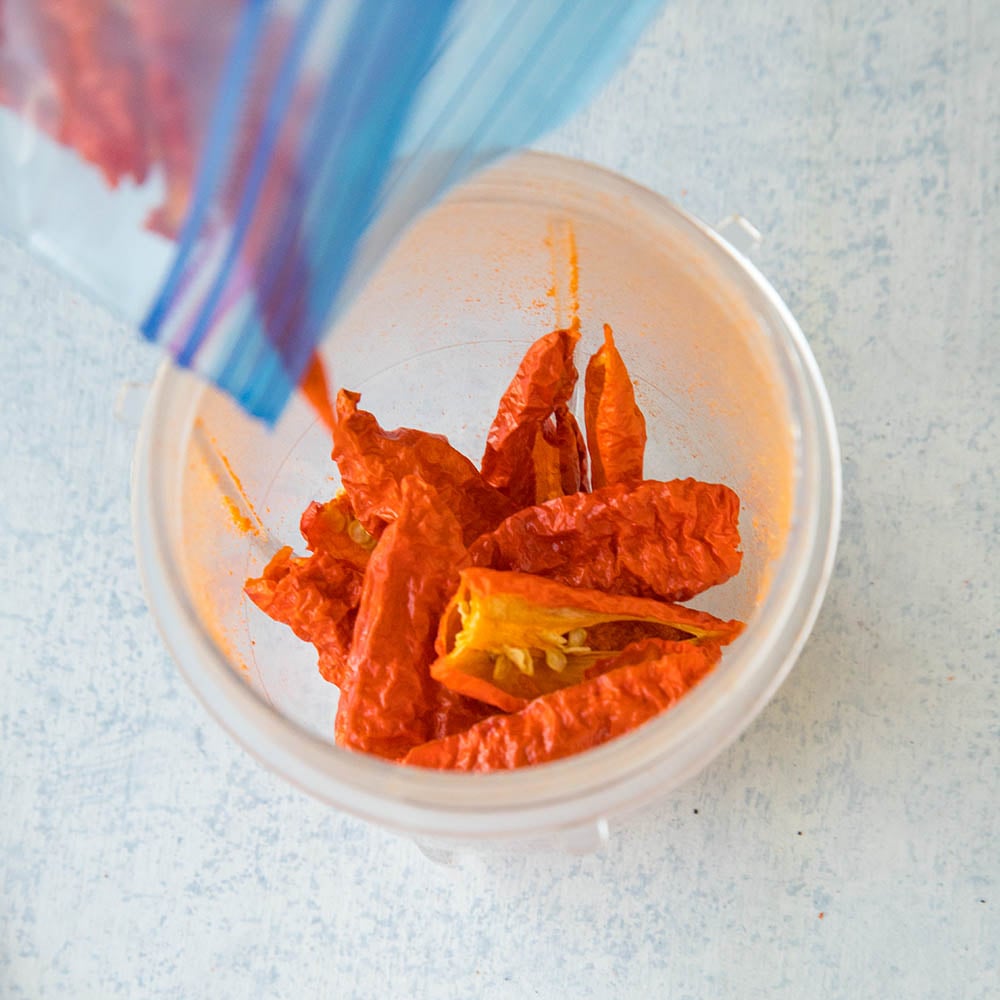 Placing Ghost Peppers in the Grinder to Make Powder.