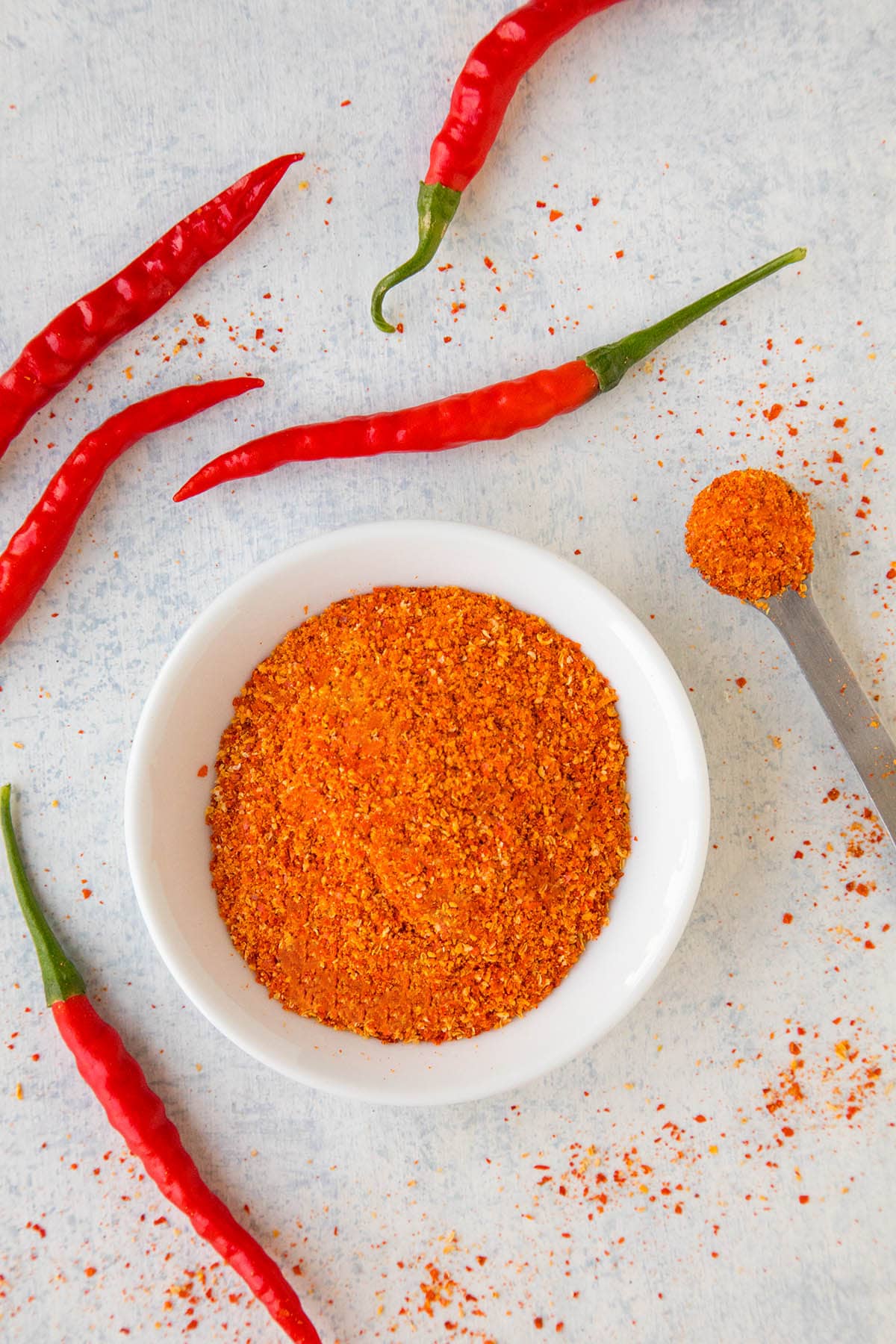 Homemade cayenne powder in a bowl on a table.