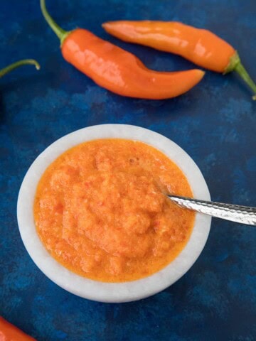 Aji Amarillo Paste with peppers around the bowl
