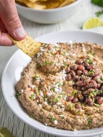 A big scoop of Black Bean Dip on a tortilla chip