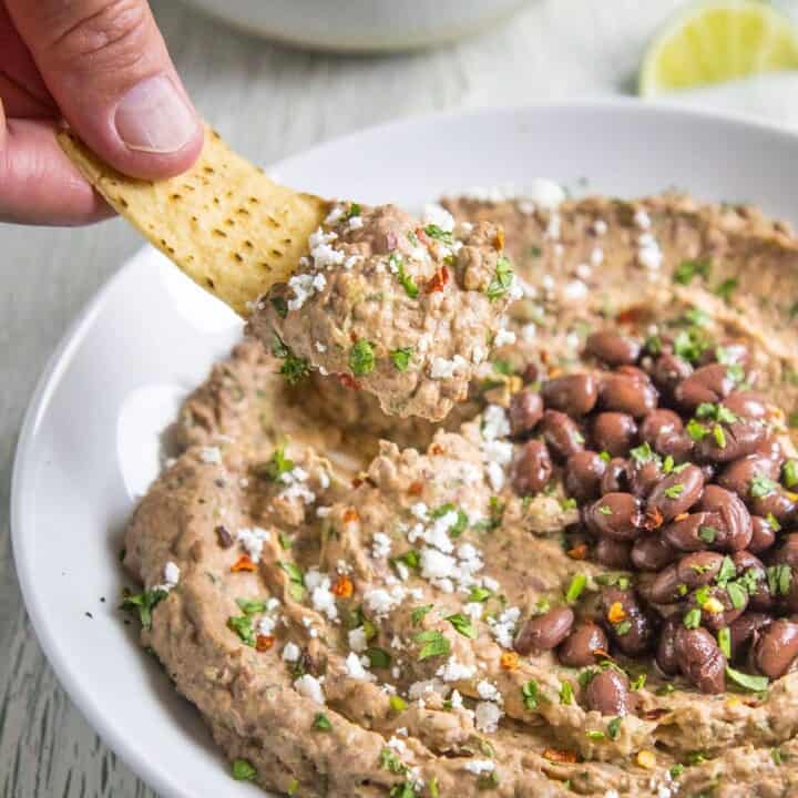 A big scoop of Black Bean Dip on a tortilla chip