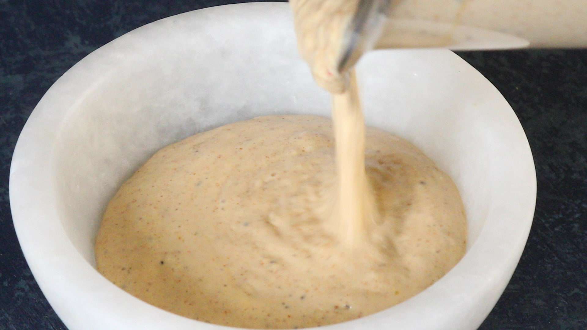 Pouring Cajun Cream Sauce into a bowl