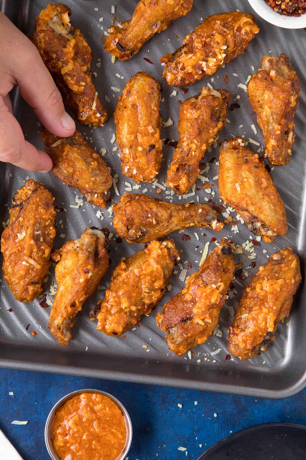 Snatching a Garlic Parmesan wing off the pan.