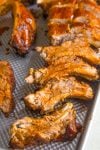 Oven Baked Ribs, sliced, on a pan with extra glazing