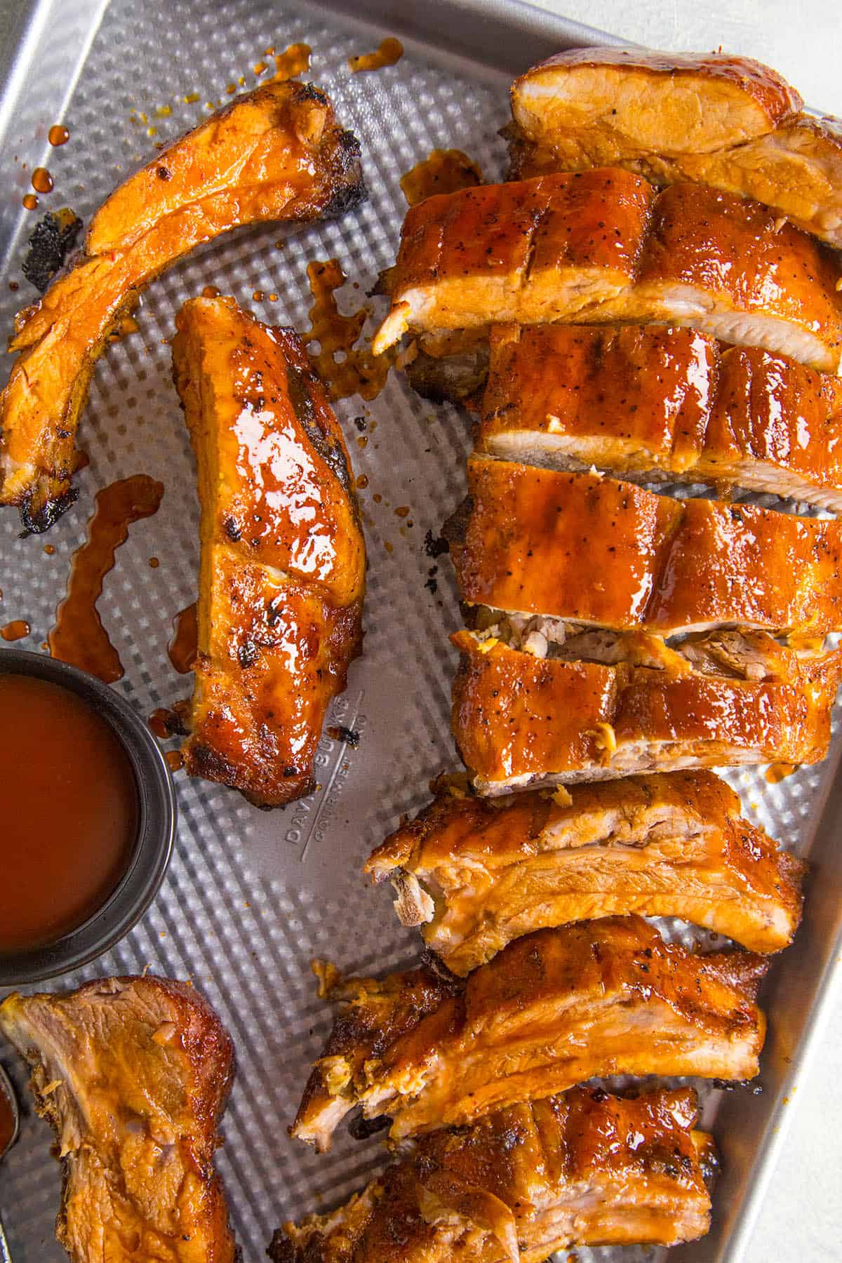 Oven Baked Ribs served on a pan with extra glazing