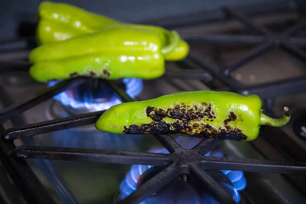 Roasting the Anaheim peppers on a stove