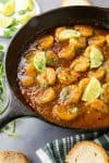 Shrimp in Fiery Chipotle-Tequila Sauce - In a pan, ready to serve, with fresh limes