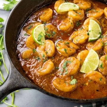 Shrimp in Fiery Chipotle-Tequila Sauce - In a pan, ready to serve, with fresh limes