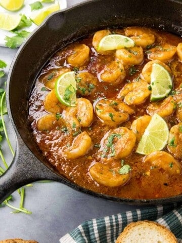 Shrimp in Fiery Chipotle-Tequila Sauce - In a pan, ready to serve, with fresh limes