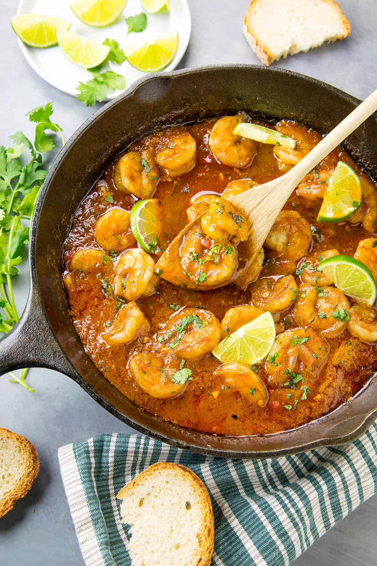 Shrimp in Fiery Chipotle-Tequila Sauce in a pan with a spoon for serving