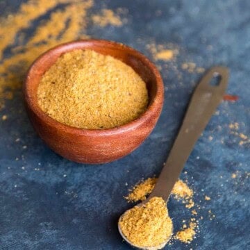 Vindaloo curry powder in a bowl and on a measuring spoon.