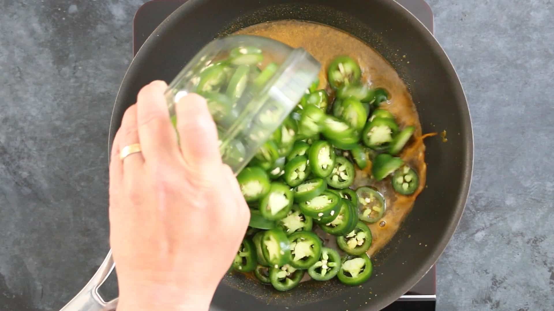 Candied Jalapenos Recipe (Cowboy Candy) Adding jalapeno peppers to the pan