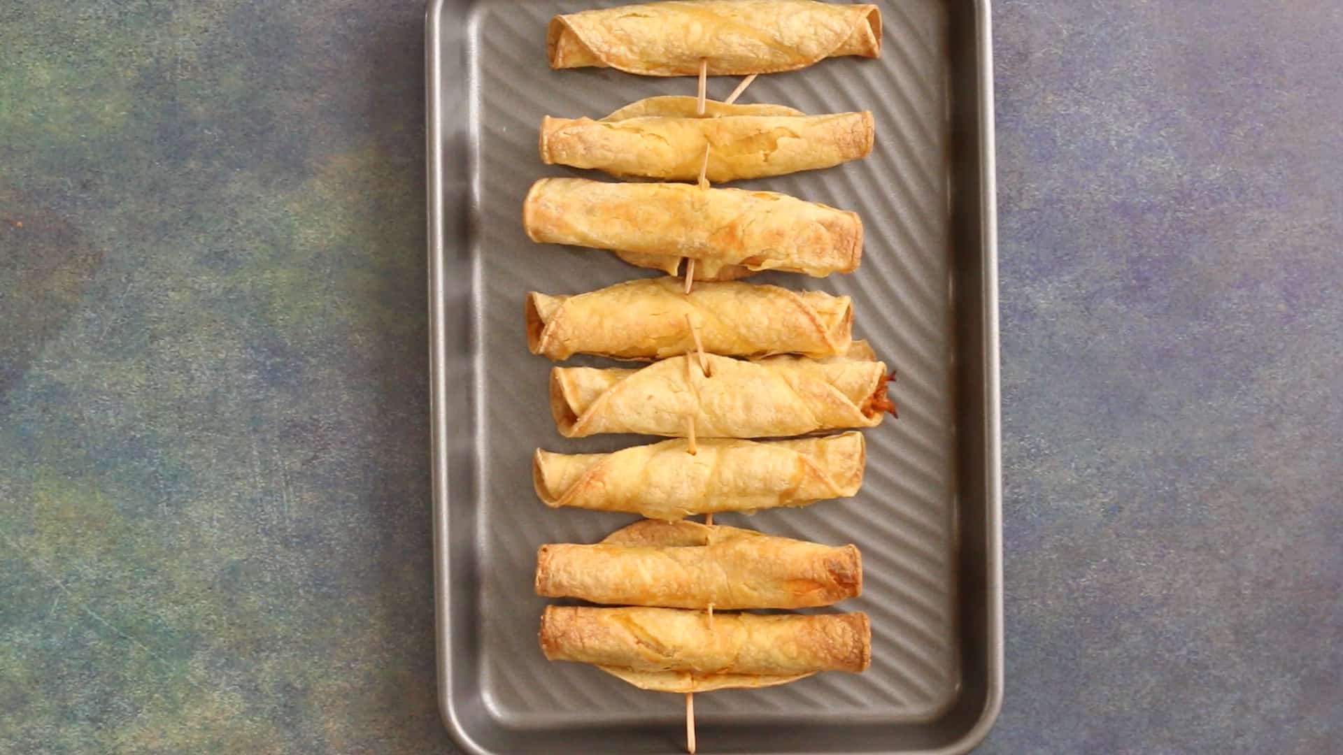 Baked Chicken Taquitos on a baking sheet.