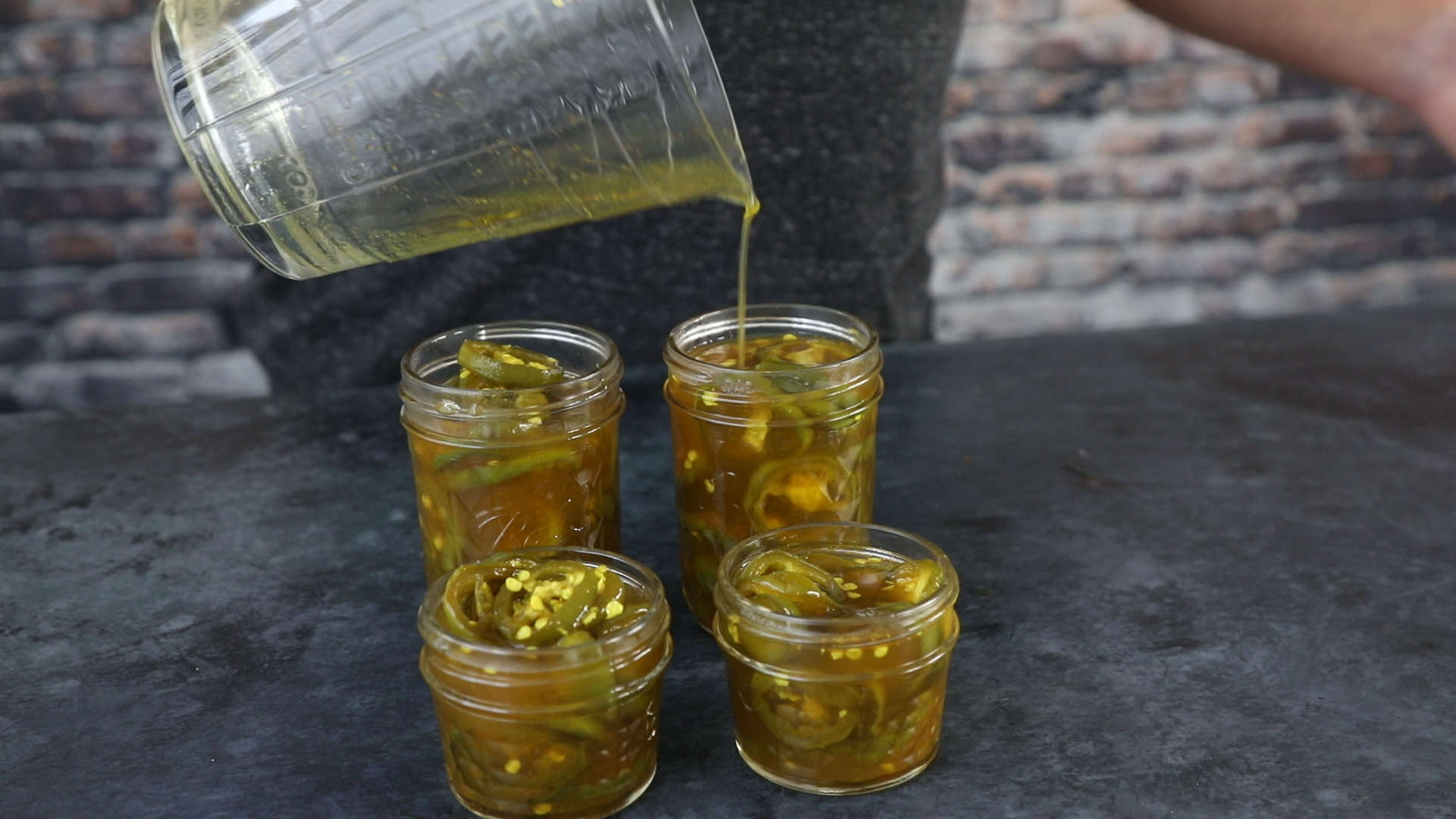 Candied Jalapenos Recipe (Cowboy Candy) Pouring the simple sugar into the jarred Candied Jalapenos (Cowboy Candy)