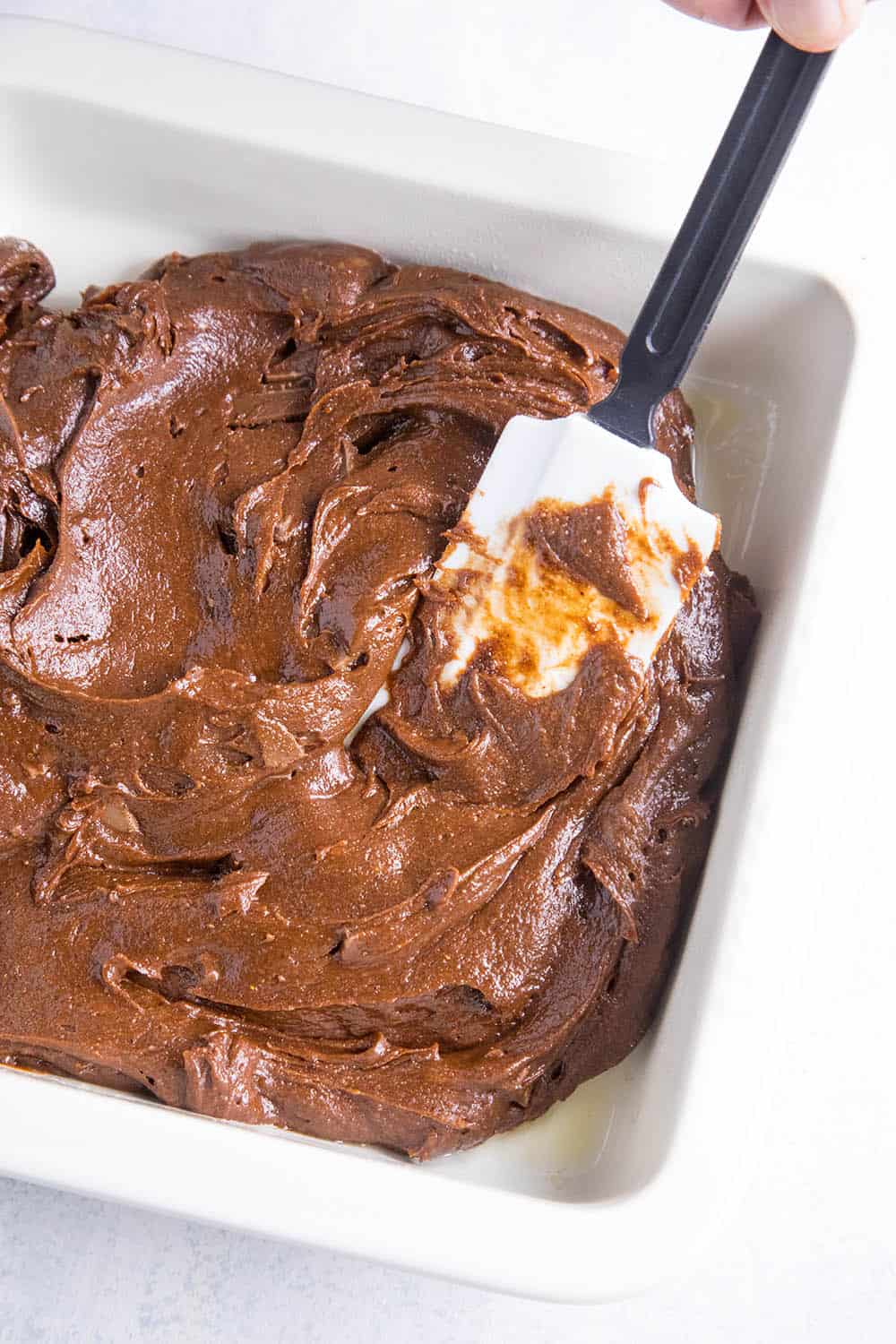 Spreading the batter in a pan to make Mexican Brownies