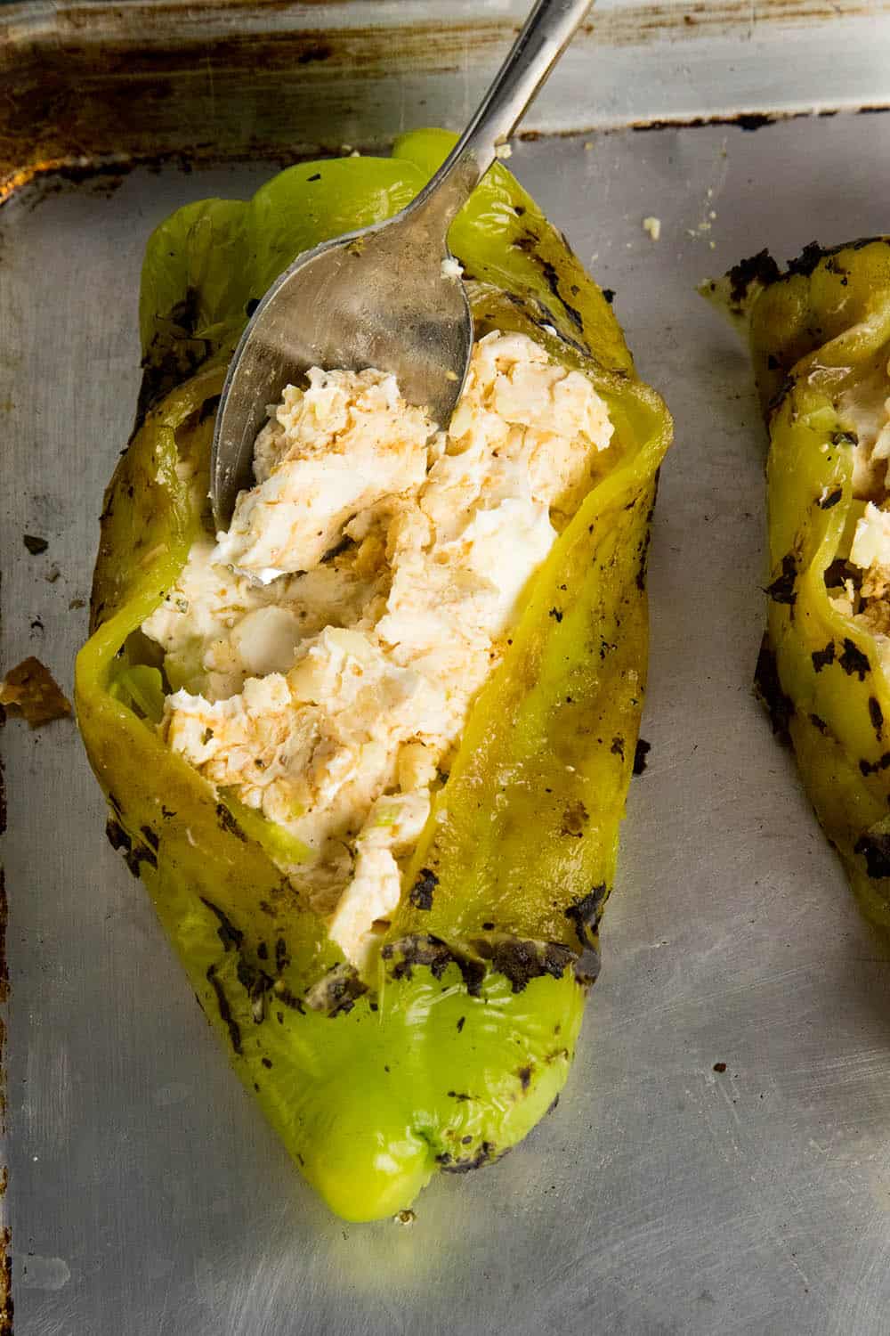 Stuffing the Anaheim peppers with Cajun cream cheese before baking
