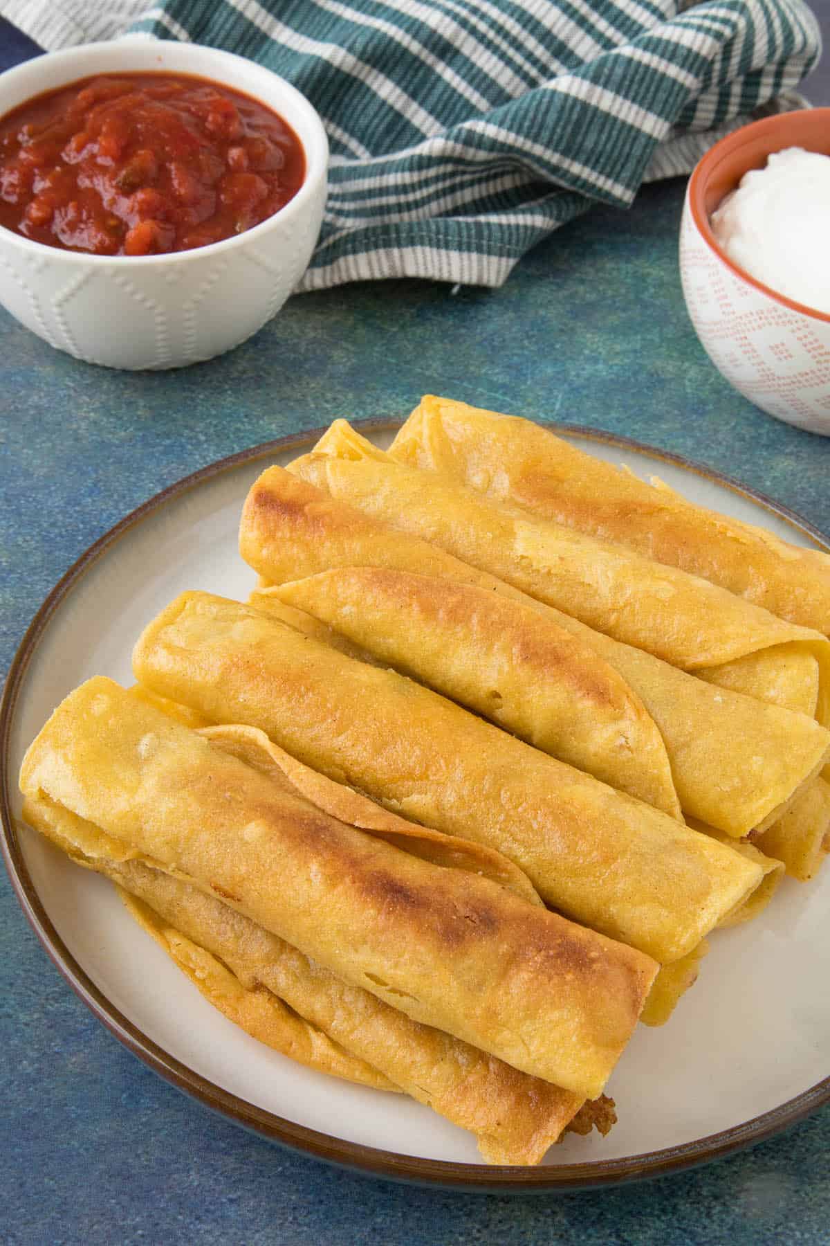 Chicken Taquitos - stacked on a plate.