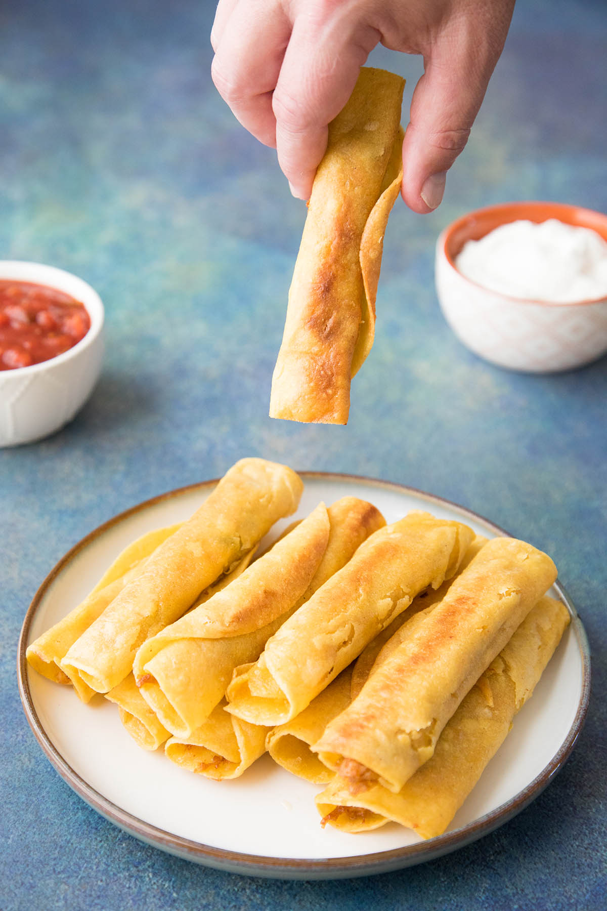 Chicken Taquitos - Grabbing one and ready to dip it in salsa to eat