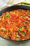 Pepperonata, a recipe for sweet bell peppers, onions and garlic simmered long and slow in olive oil, making a hugely flavorful and tender dish that can be enjoyed as a spread or a sauce.