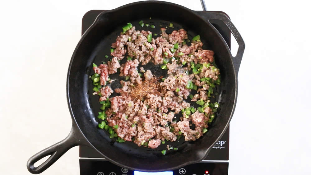 Adding chili powder to the pan