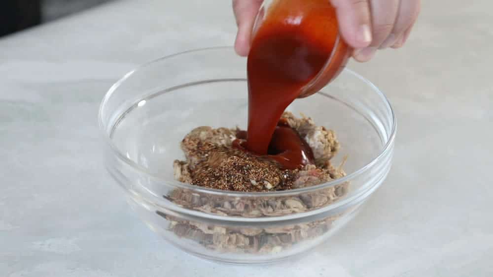 Making our stuffing mix with pulled pork, sriracha, chili powder and garlic