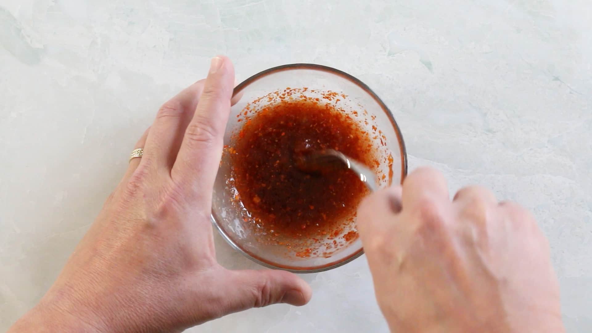 Mixing together the spicy ghost pepper mixture to make ghost pepper candied bacon