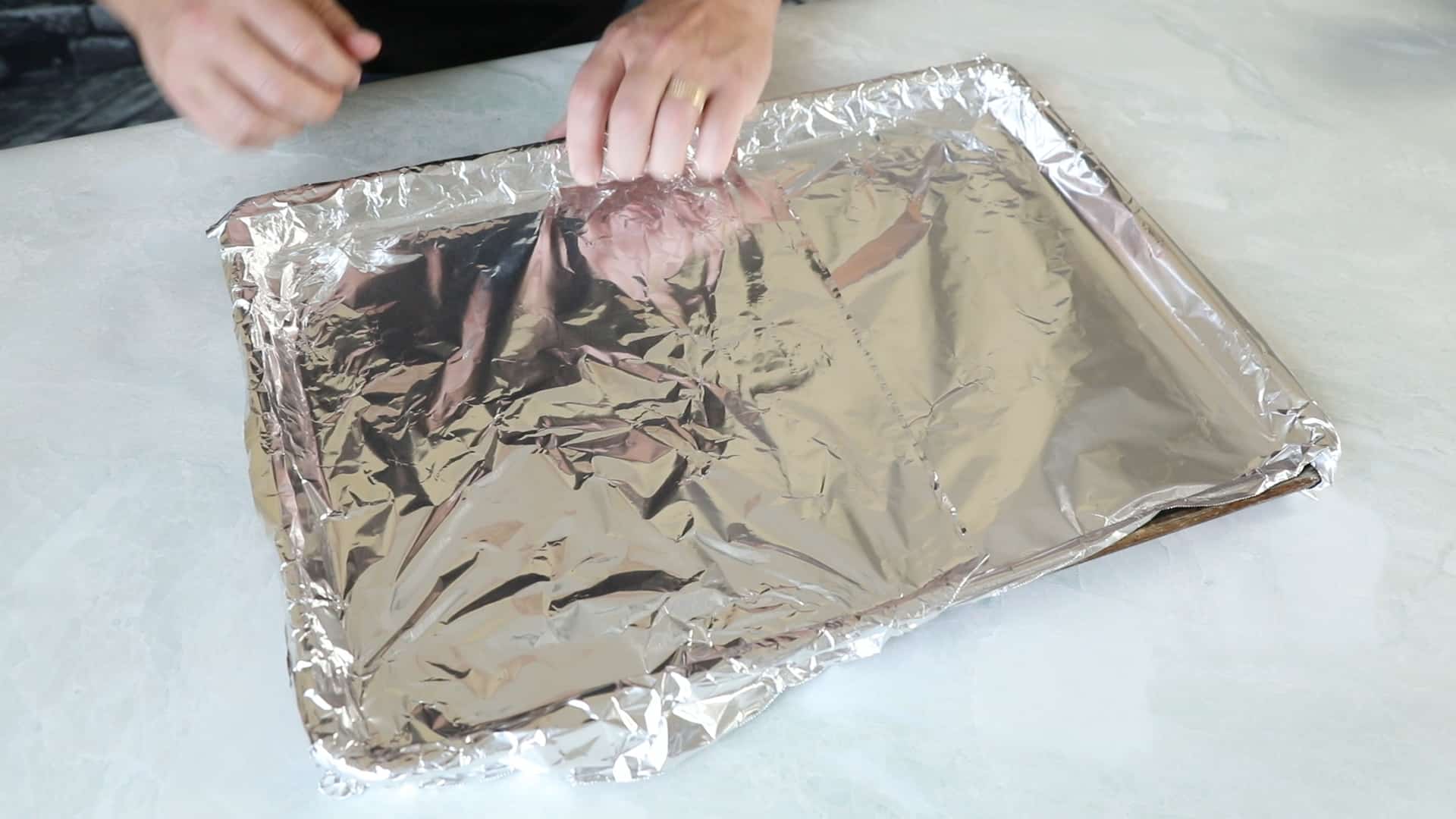 Sweet and Spicy Ghost Pepper Candied Bacon - Recipe Covering a baking sheet with aluminum foil