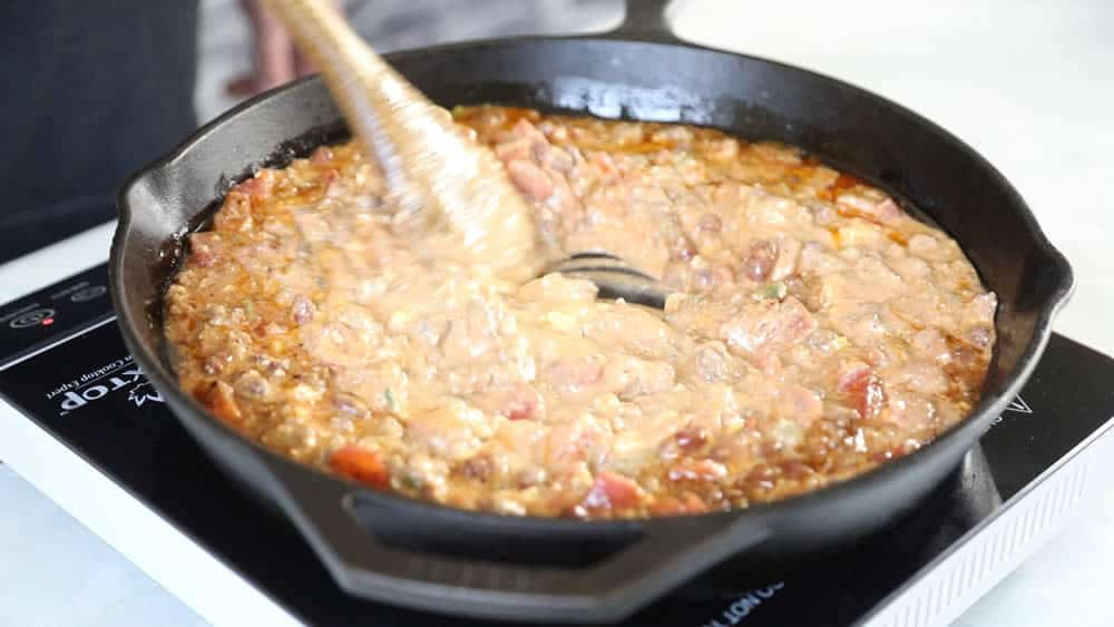 Stirring cream cheese into the chili cheese dip