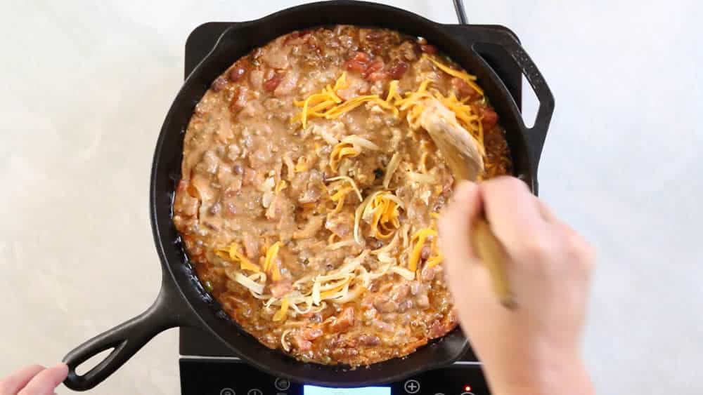 Stirring cheese into the chili cheese dip