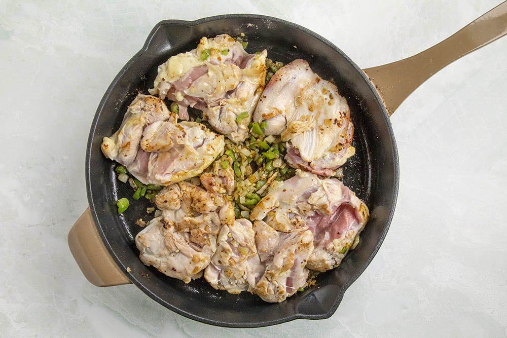 Chicken thighs searing in a pan to make our chicken tinga