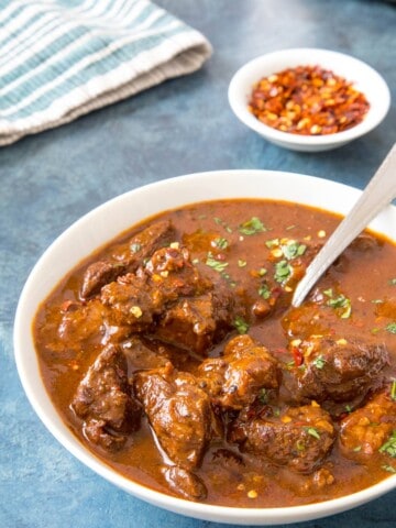 Chili Con Carne in a bowl with a spoon, ready to eat