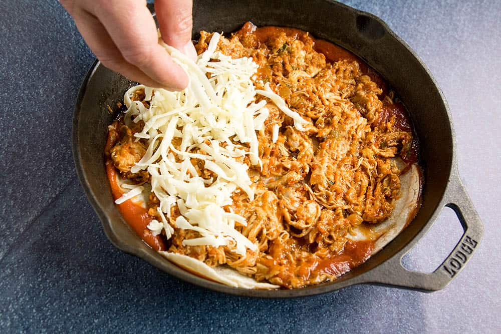 Adding cheese to the Chipotle Chicken Enchilada Casserole