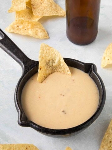 Creamy Beer Cheese served in a bowl with chips around it