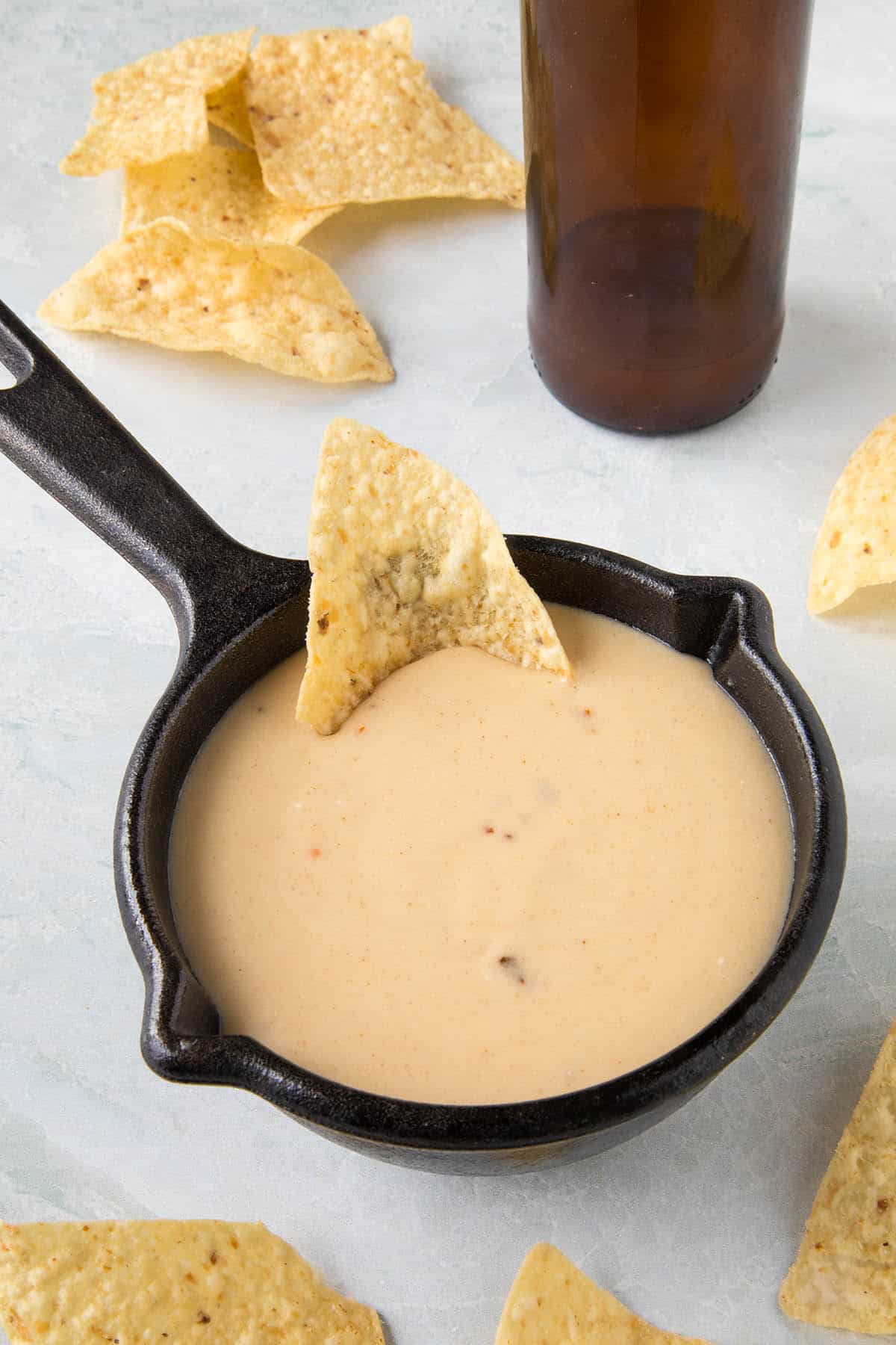 Creamy Beer Cheese served in a bowl with chips around it