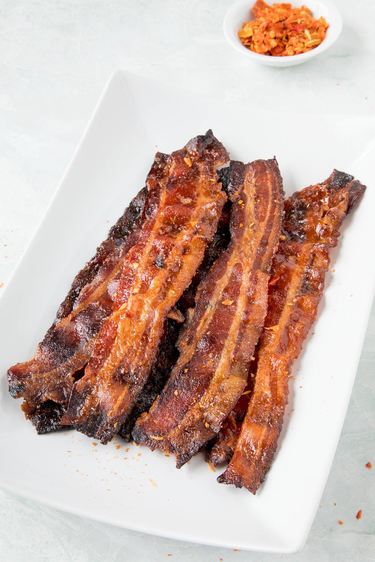 Ghost Pepper Candied Bacon - Stacked on a plate