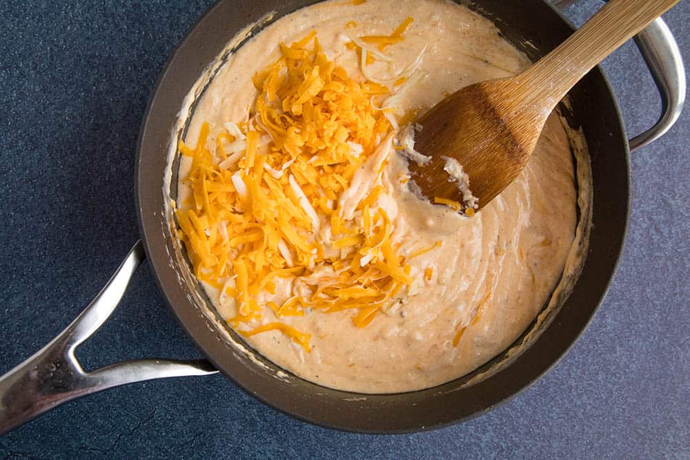 Stirring the cheese into the roux