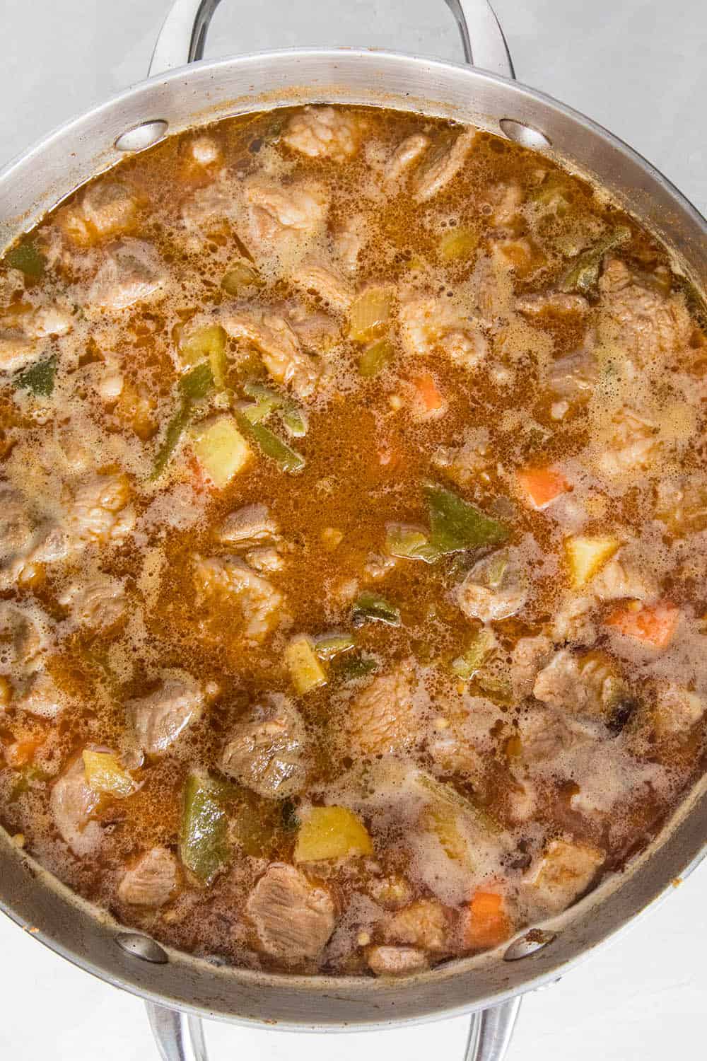 Green Chili Stew with Pork simmering in a pot