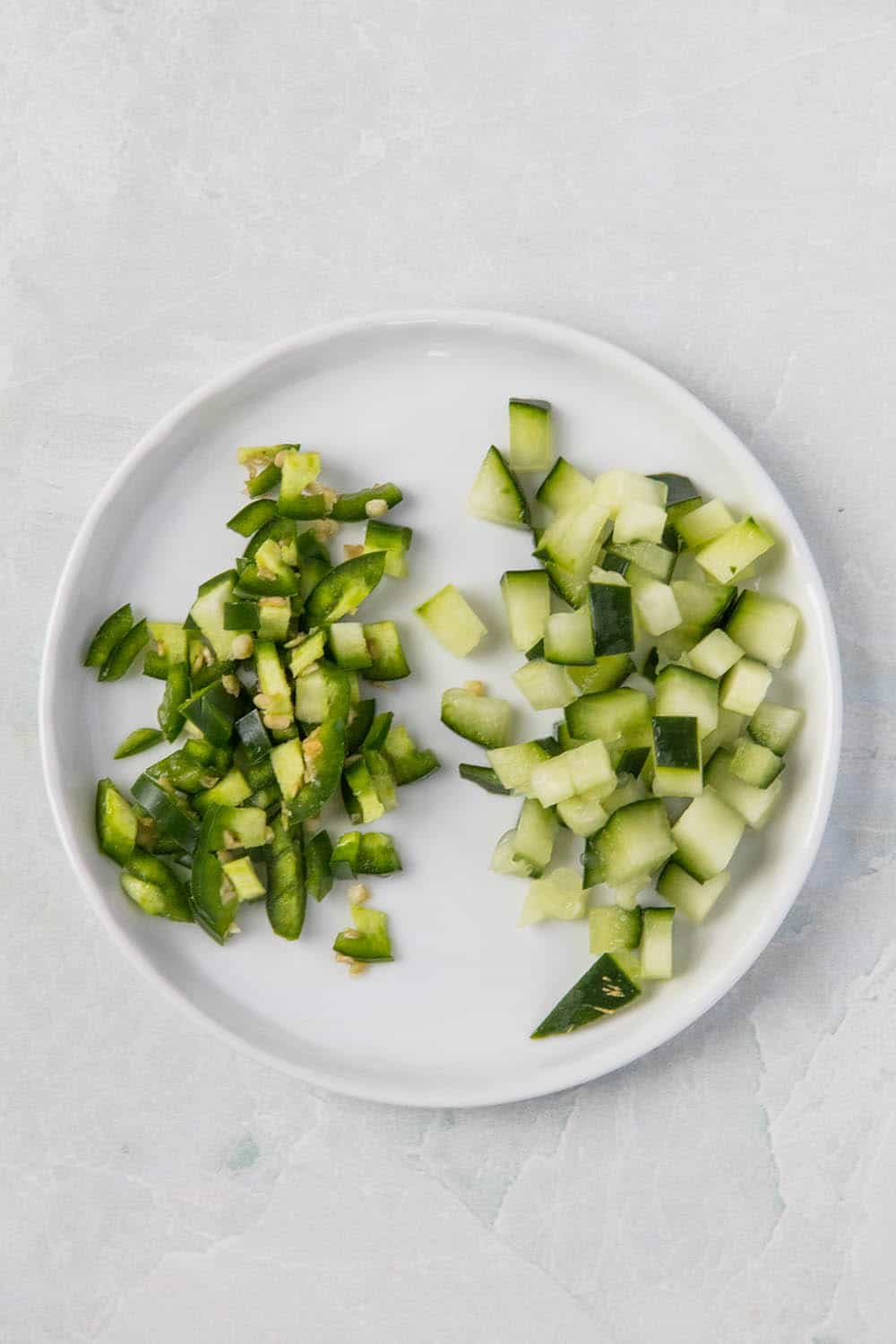 Diced cucumbers and serrano peppers.