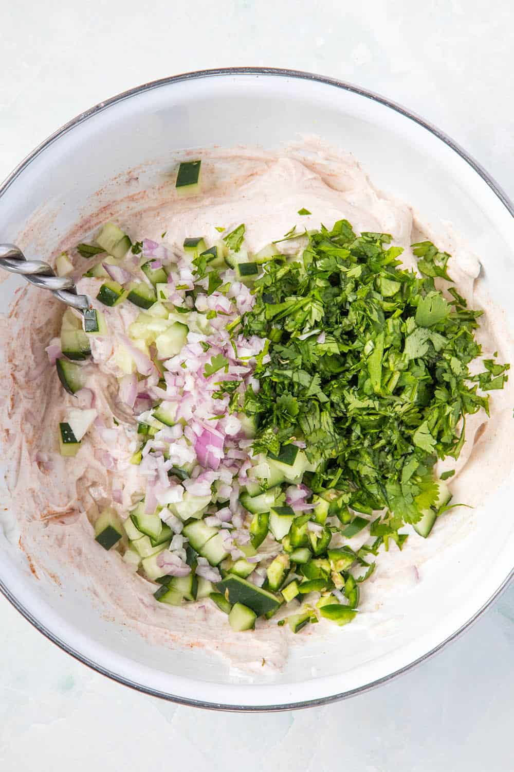 Mixing our Raita in a bowl.