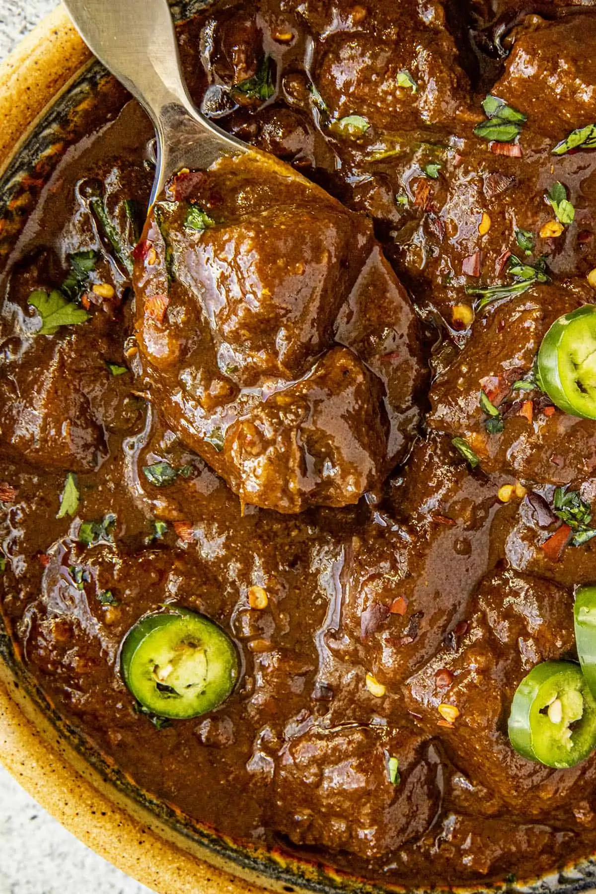 A big bite of meaty Texas Chili on a spoon