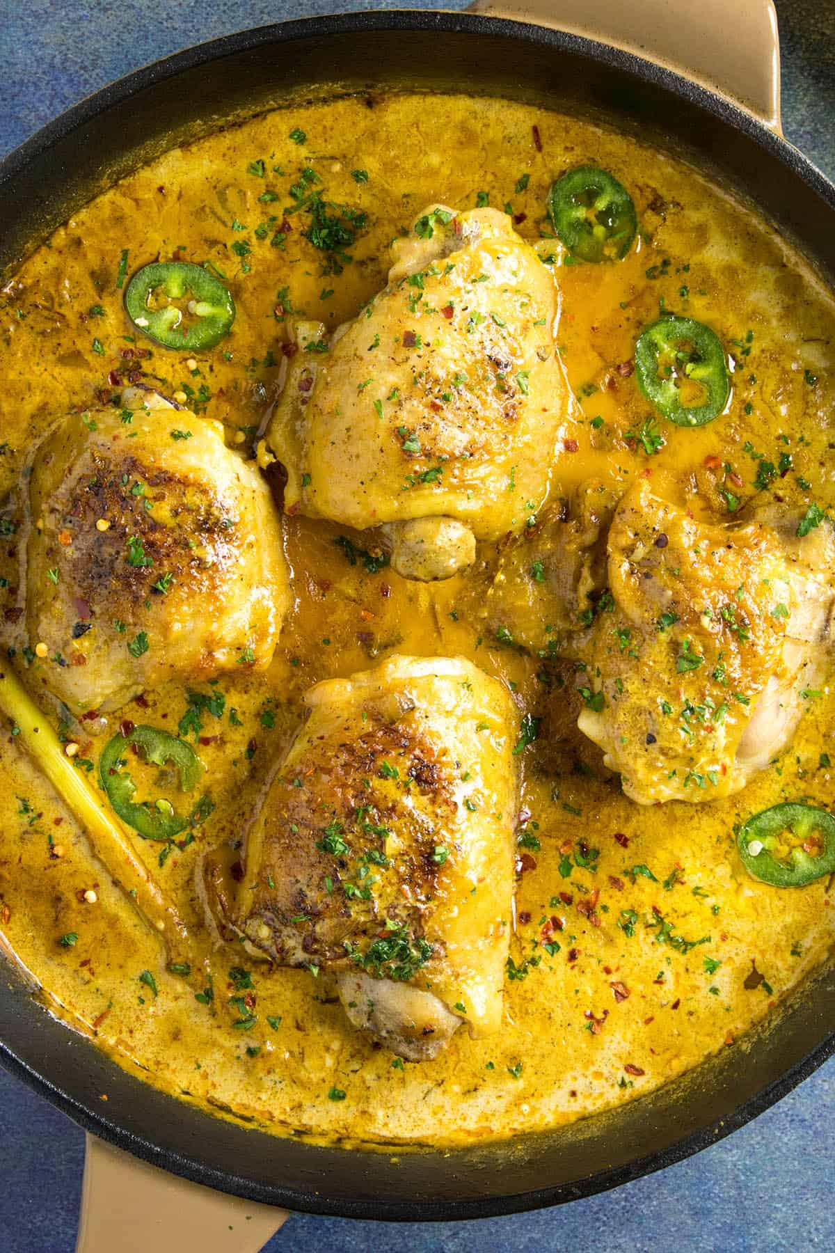 Coconut Curry with Chicken Thighs, in a pan, simmering